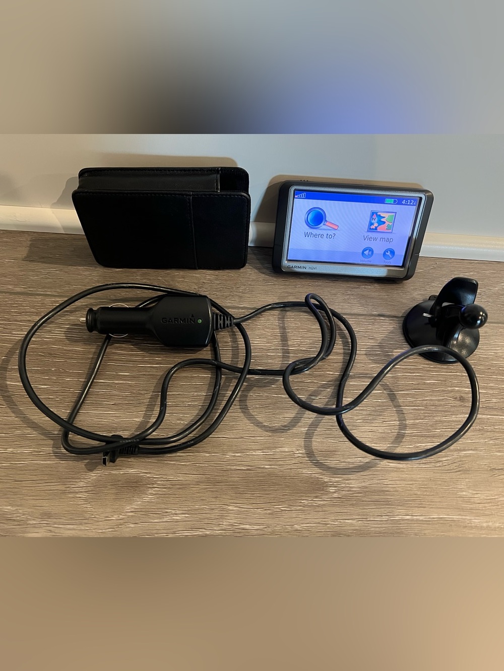Pre-owned Garmin nüvi portable GPS navigation bundle.
